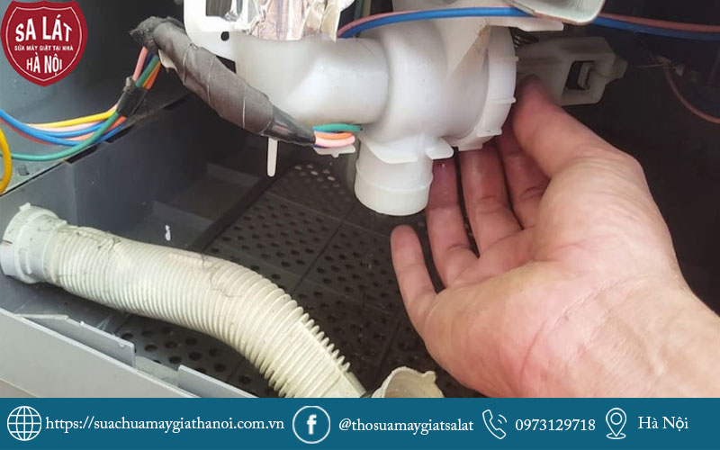 Thợ kỹ thuật đang tiến hành kiểm tra và vệ sinh van xả nước máy giặt